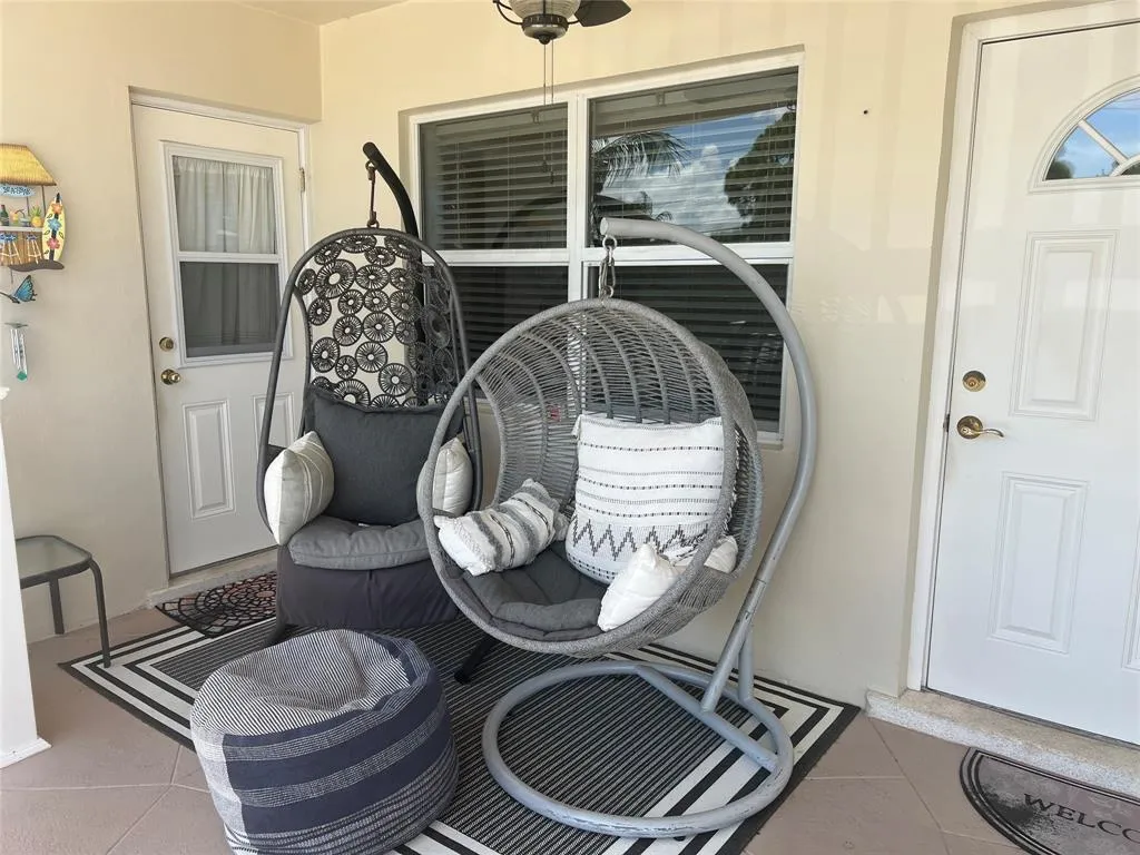 Comfortable front porch with 2 entrance doors to the apartment.
