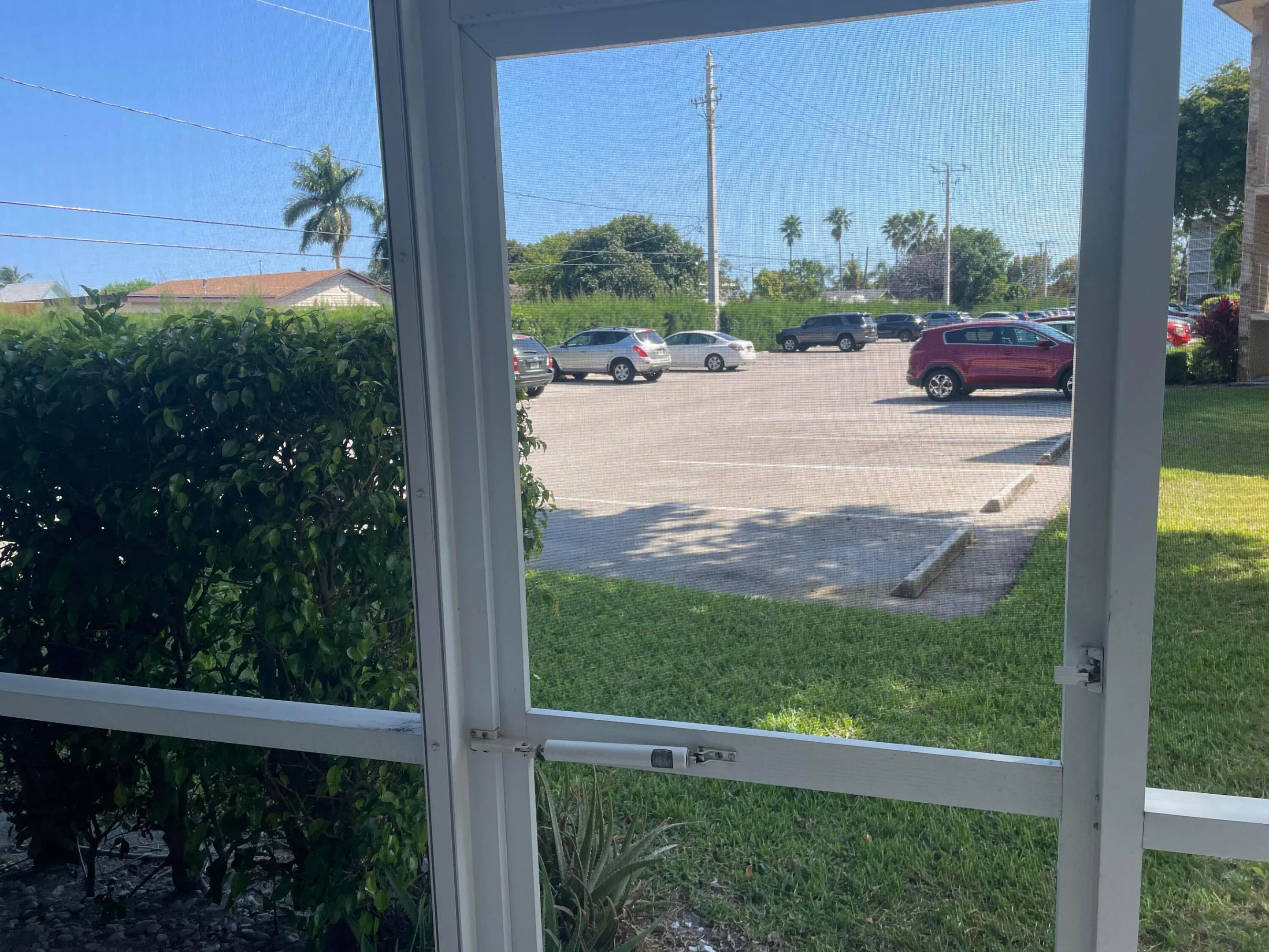 Screen door for egress to back of condo