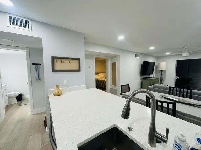 Ceiling with recessed lighting, bright beautiful blinds throughout the unit