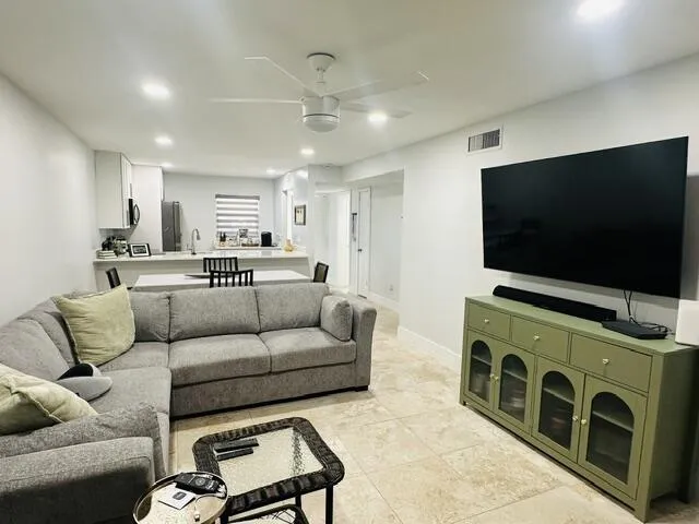 living room leads into an nother enclosed patio with pull out couch- closed with brand new hot water heater