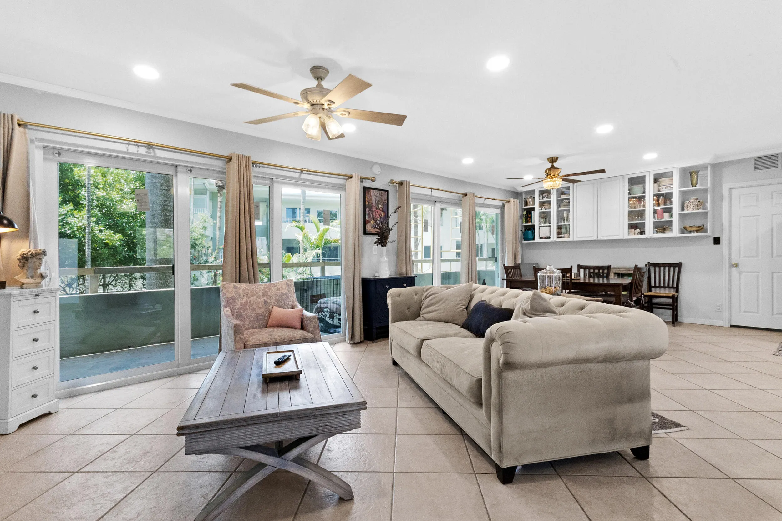 Large living area with impact sliders and garden/pool views