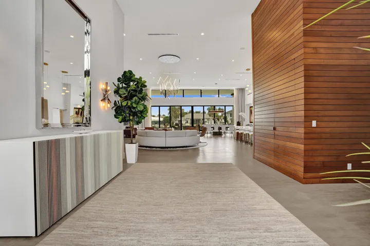 Foyer entry to great room. Powder room entrance in the integrated wood wall