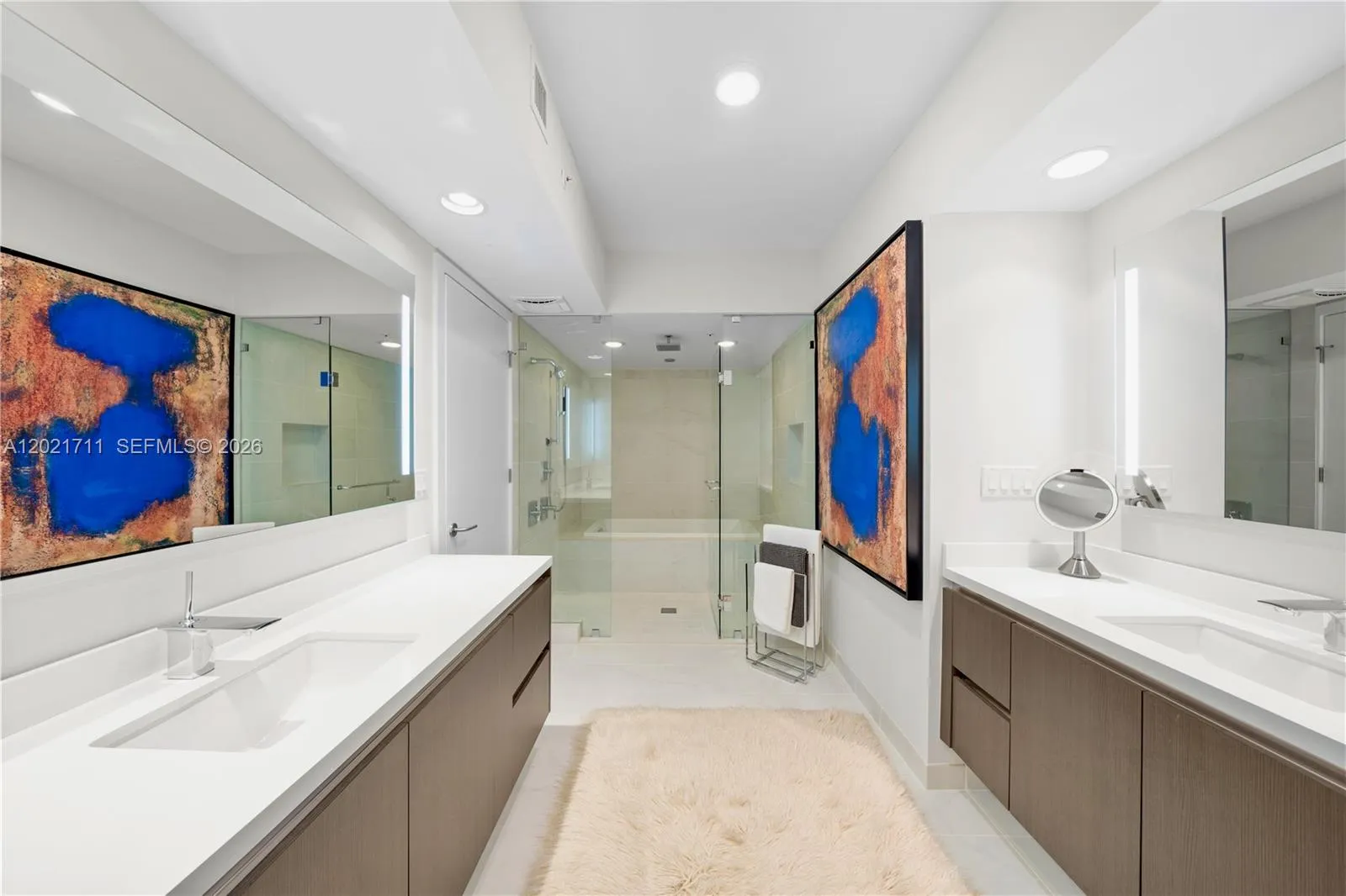 Primary Bath with Dual, Backlit Vanities, Shower & Tub.