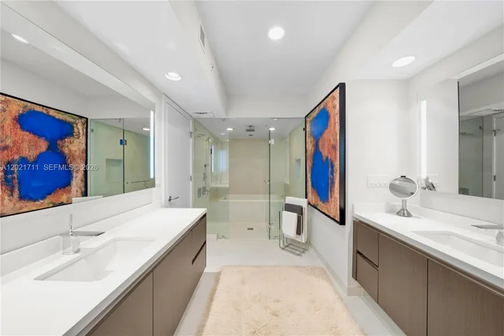 Primary Bath with Dual, Backlit Vanities, Shower & Tub.