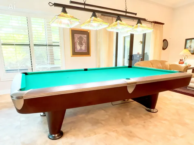 Pool table view from the kitchen. The area located off the kitchen and main living is large enough for a generous-sized table or pool table.