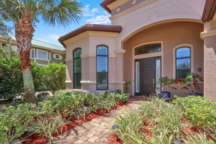 Pavers line the driveway, walkway, and front porch