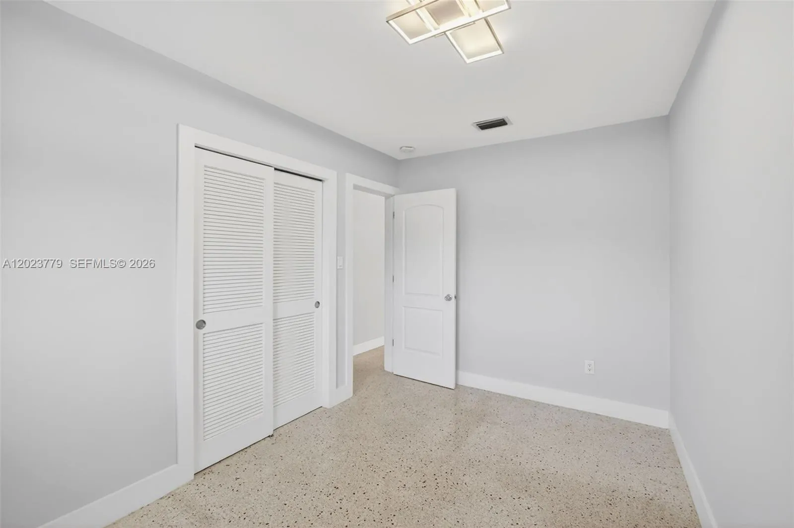 Guest bedroom w/ terrazzo floors - freshly painted