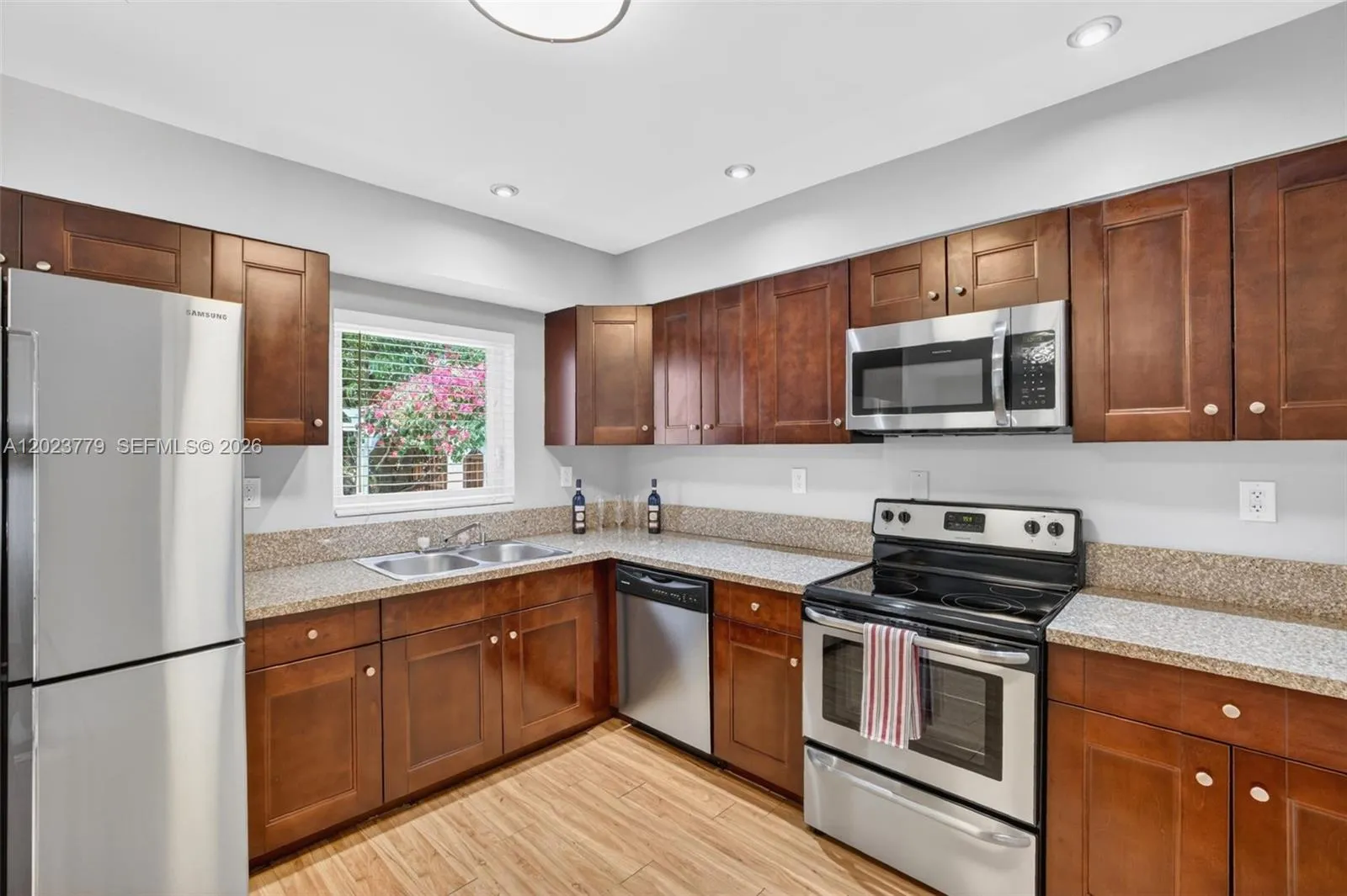 Granite Counters, Wood Cabinets and Stainless Appliances w/ window overlooking to backyard