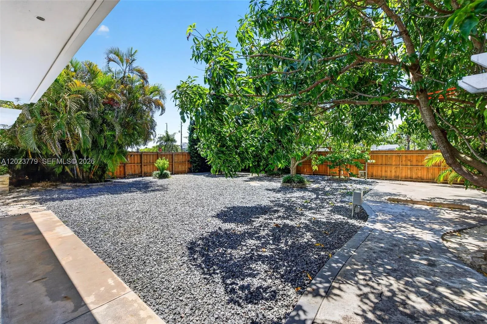 Large inviting backyard w/ stone chips and tons of fruit trees. Electric back gate to allow extra parking for your RV, Boat, Trailer or additional vehicles. Reinforced concrete back driveway