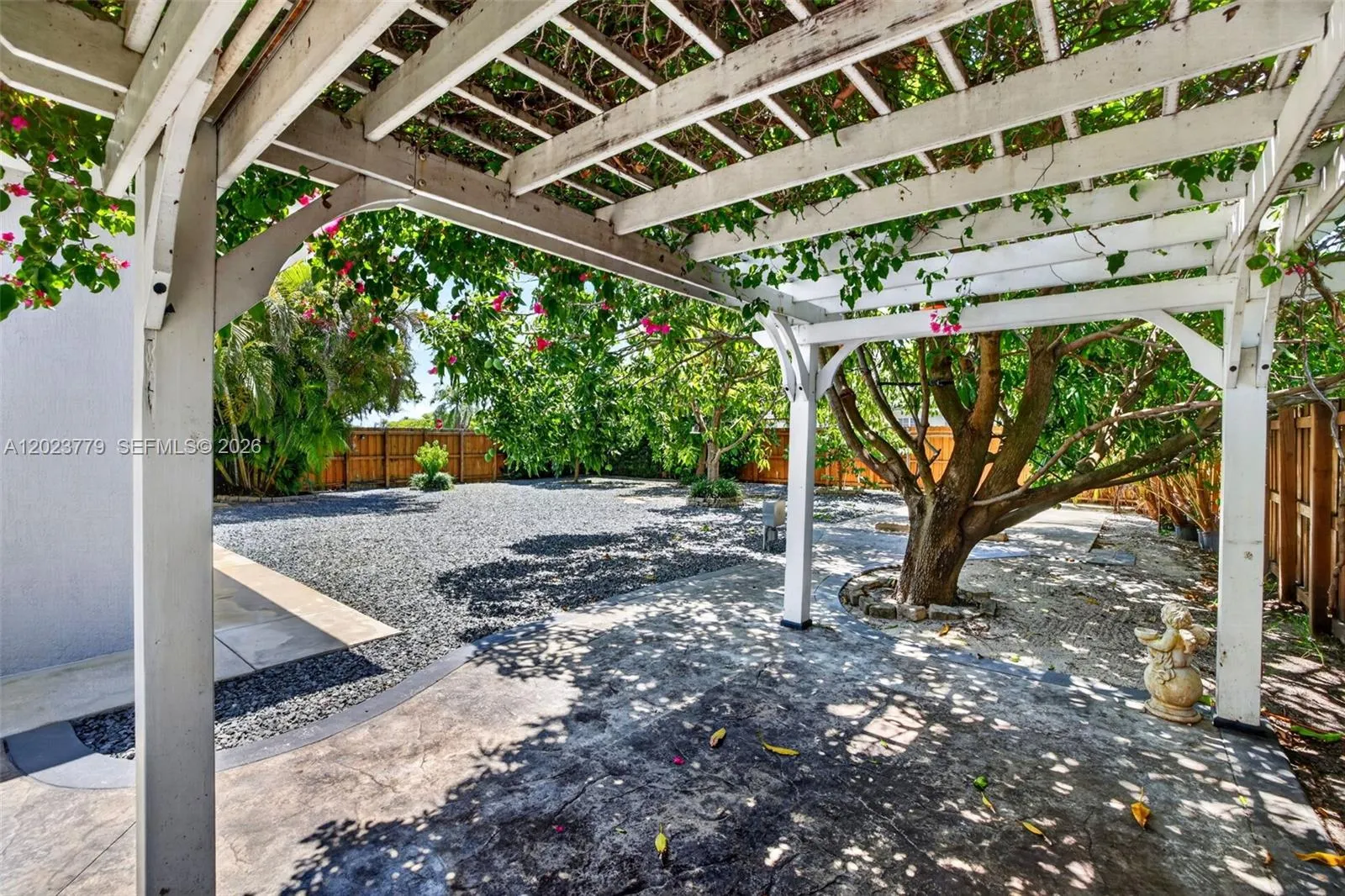 Pergola w/ flower vines growing over it for extra seating area or a great place for outdoor workouts or worksite for your crafting and hobbies