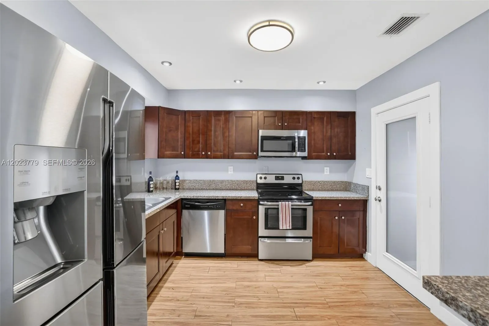 Granite Counters, Wood Cabinets and Stainless Appliances w/ window overlooking to backyard