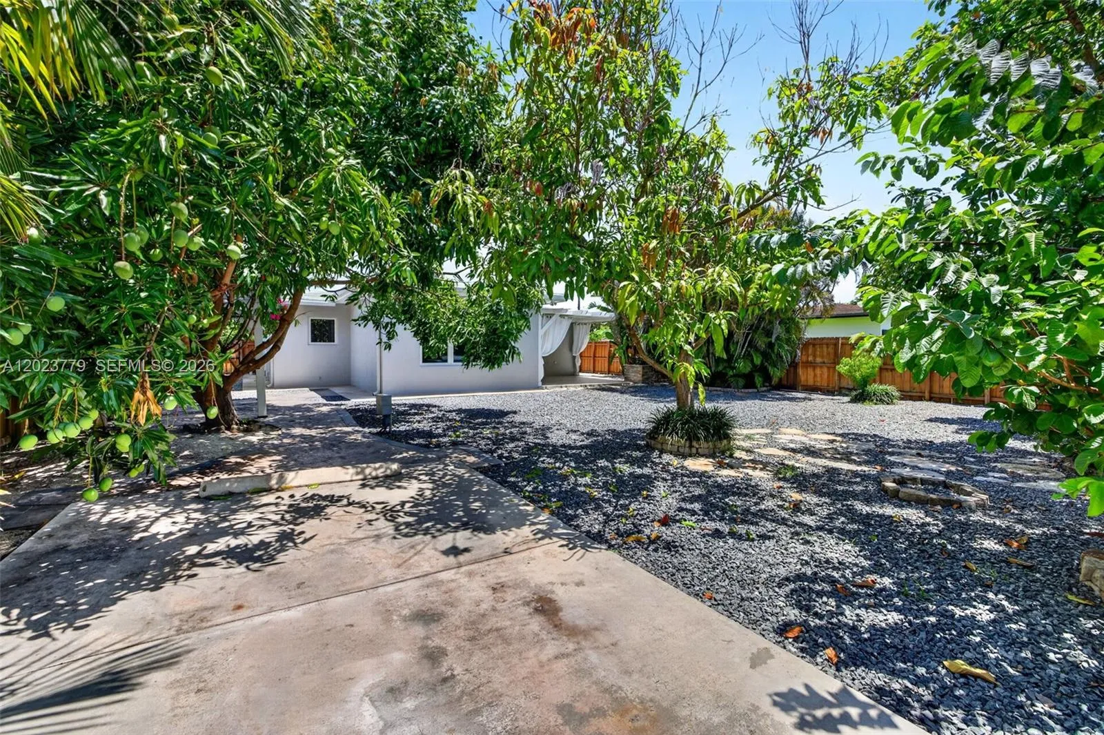 backyard extra long driveway leading from the back electric gate