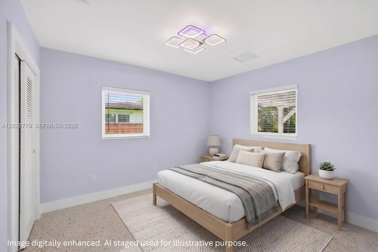 Guest bedroom overlooking covered patio in backyard. Virtually staged