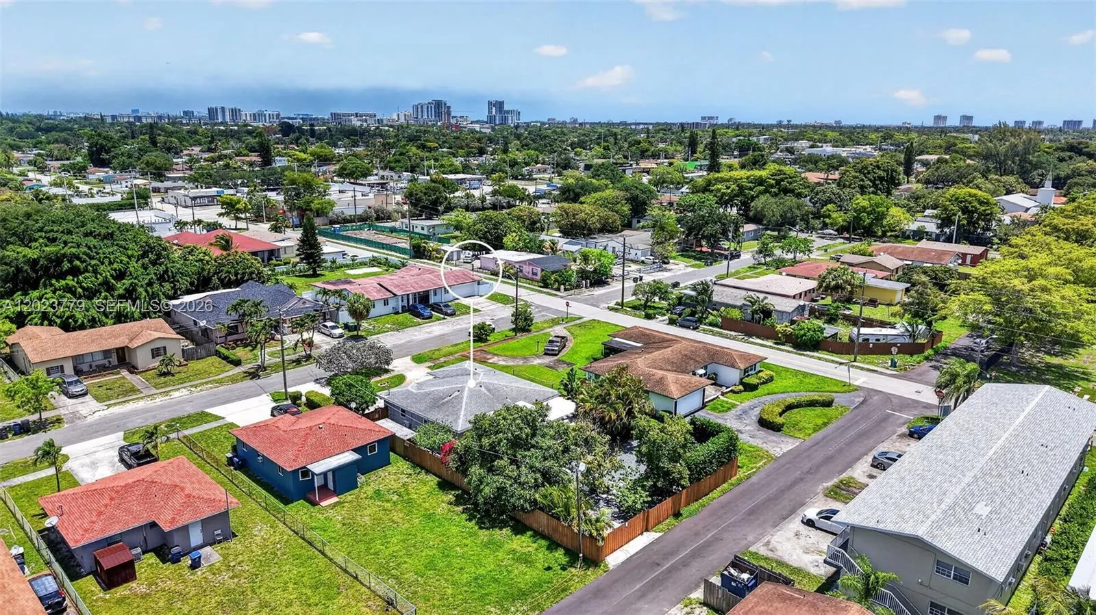 Mature tropical trees on the property - back alley way to the gated extra parking space.