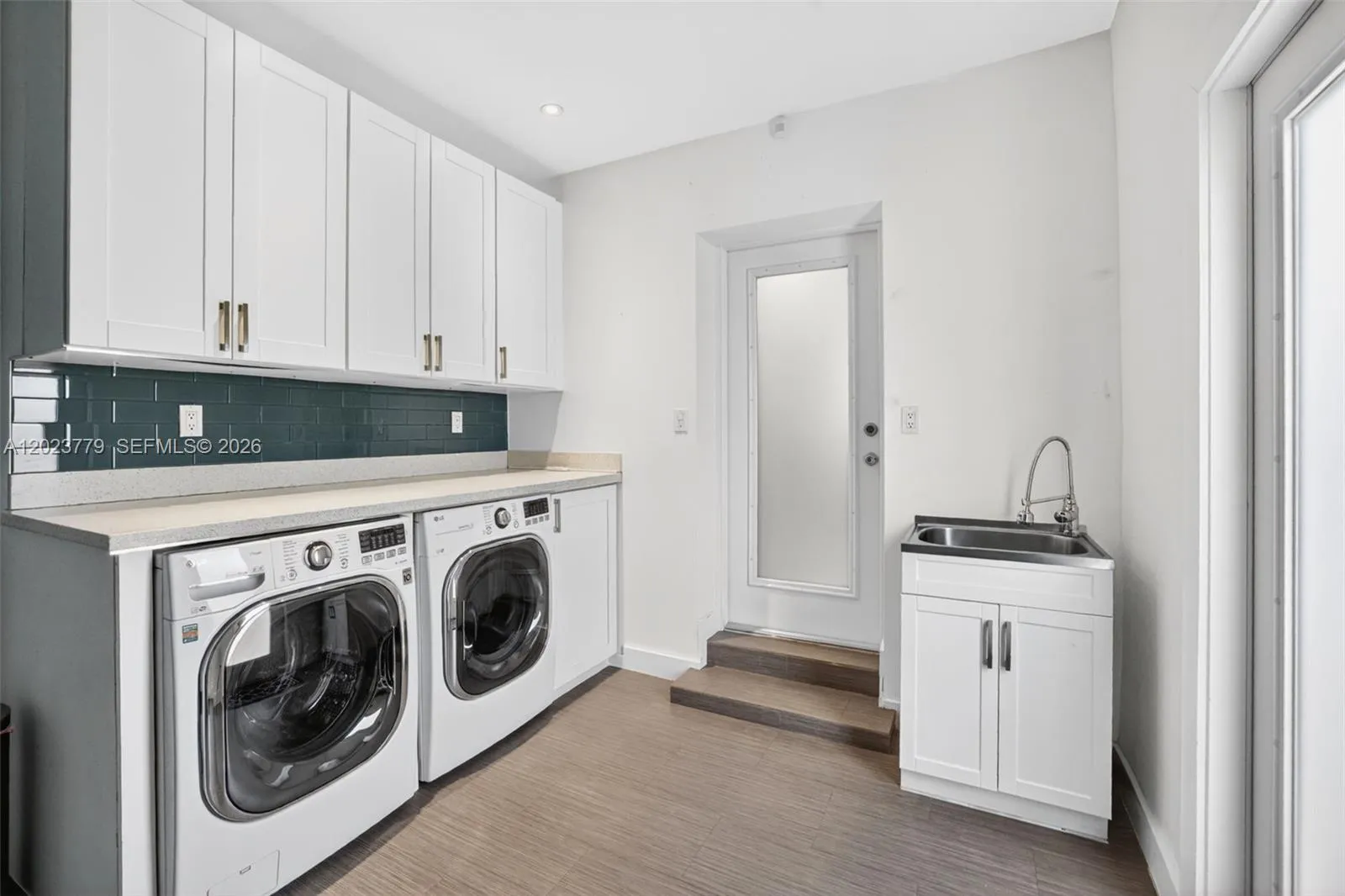 Laundry area w/ granite counter and extra storage in garage. Work sink, Garage has extra AC system