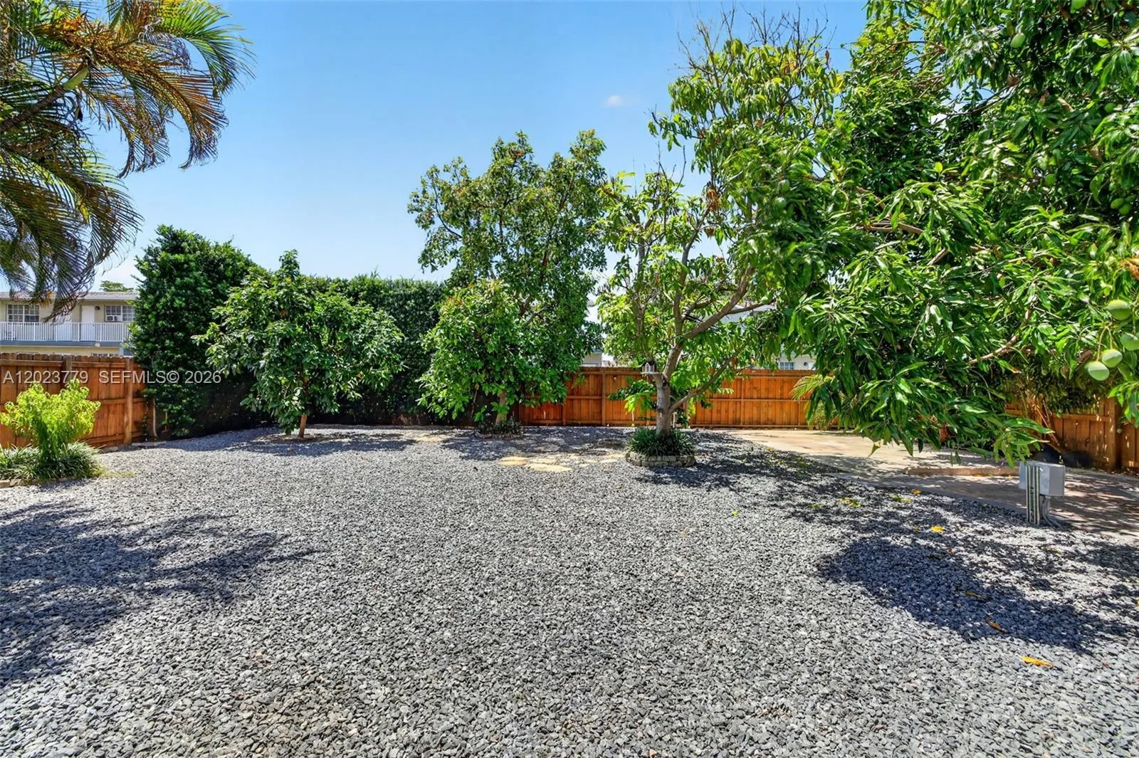 Large inviting backyard w/ stone chips and tons of fruit trees. Electric back gate to allow extra parking for your RV, Boat, Trailer or additional vehicles