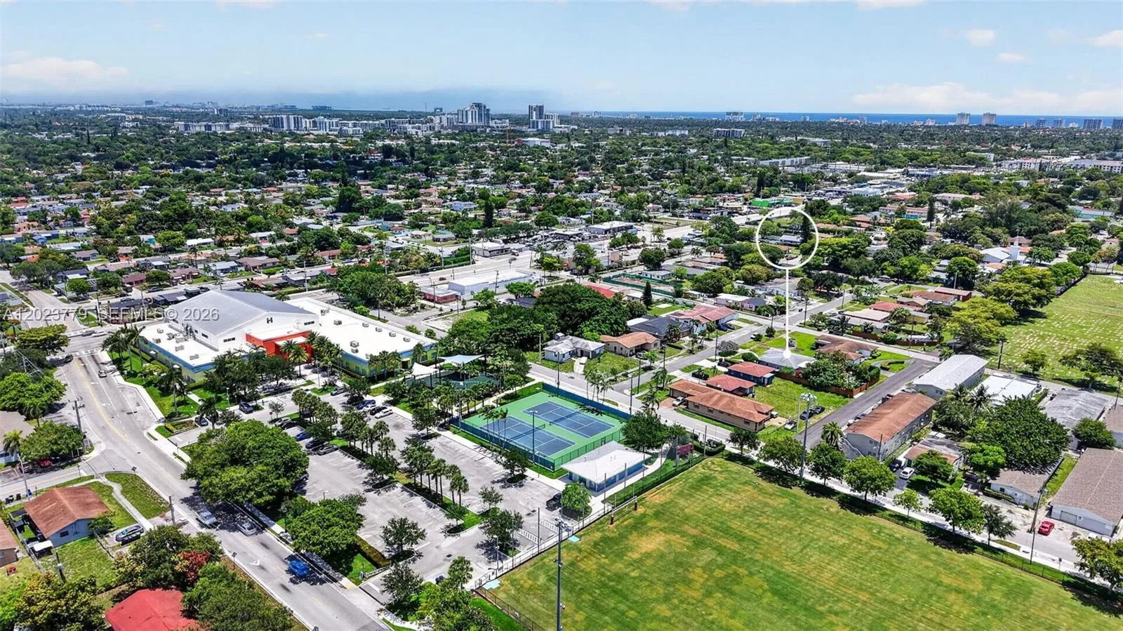 View to the city park with tons of amenities (Gym, Tennis, Playgrounds etc for just $11/month). Notice the parking lot nearby as well