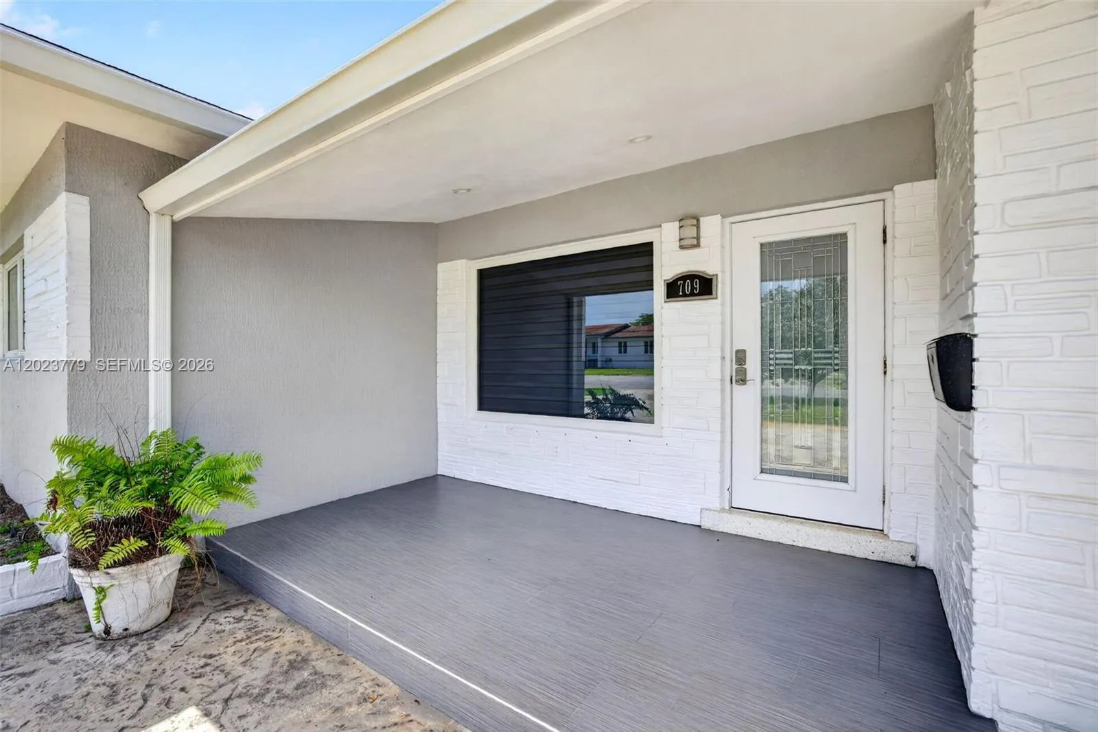 Large covered entrance w/ impact window & door