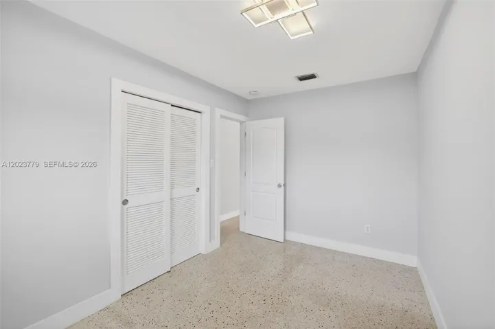 Guest bedroom w/ terrazzo floors - freshly painted