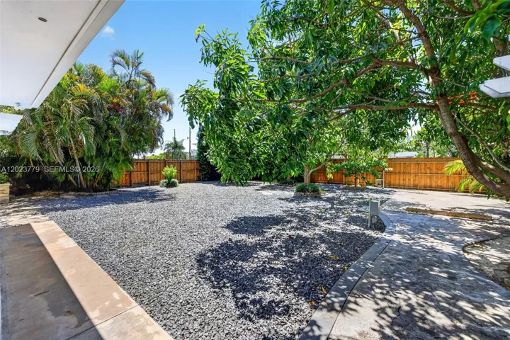 Large inviting backyard w/ stone chips and tons of fruit trees. Electric back gate to allow extra parking for your RV, Boat, Trailer or additional vehicles. Reinforced concrete back driveway