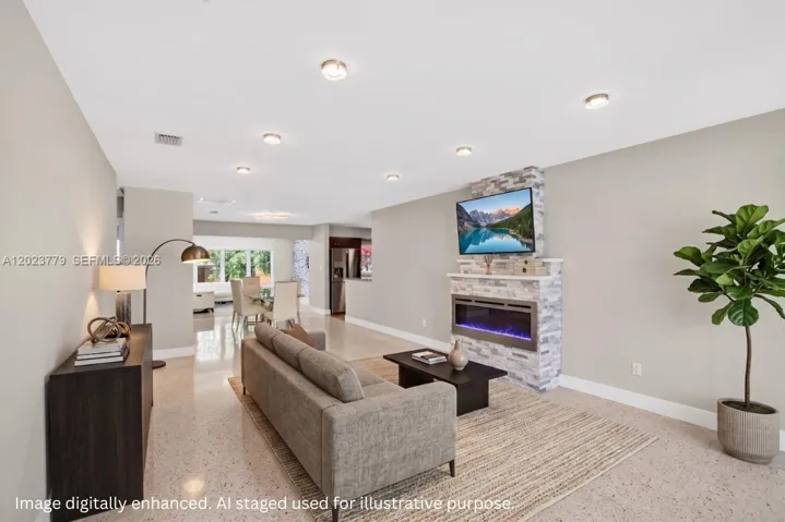Stacked Stone Electric Fireplace with color changing light, lots of high hat lighting, beautiful restored polished terrazzo flooring. Flat ceilings and neutral beautiful paint. Virtually staged