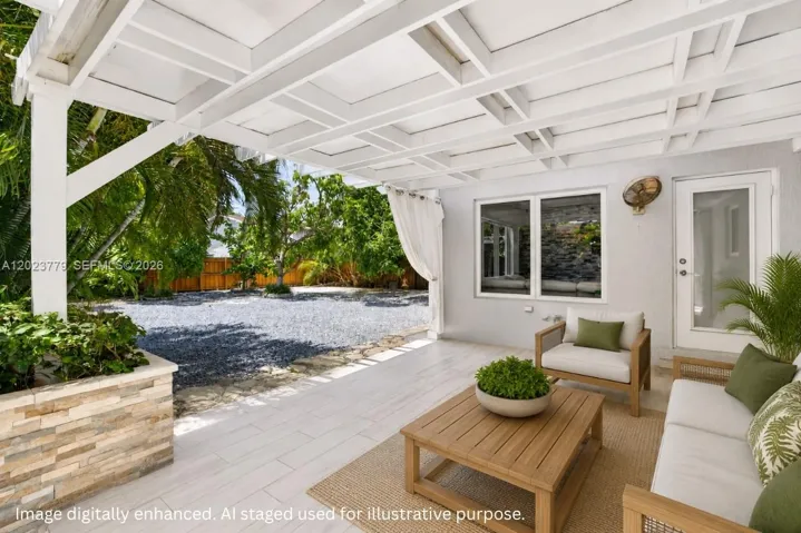 Covered Patio w/ tiled floor and stacked stone planter box. Virtually staged / enhanced