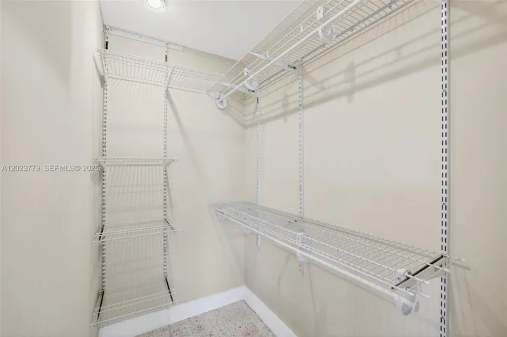 Primary walk in closet w/ upgraded adjustable shelving