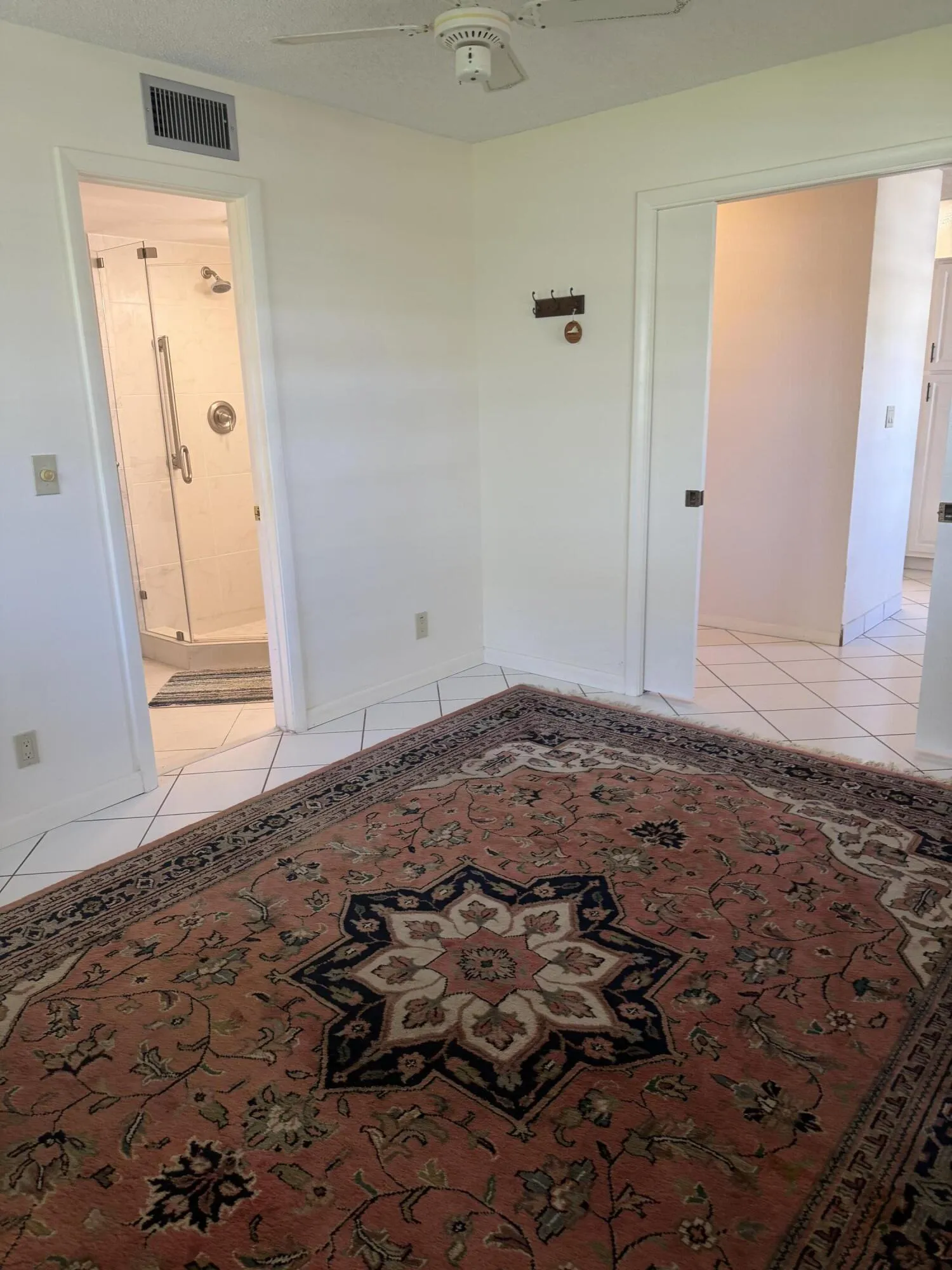 Second bedroom/den with white tile floors; rug optional
