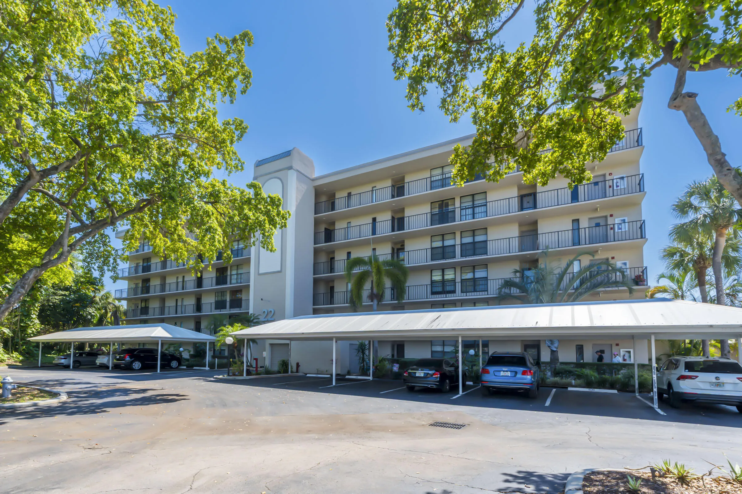 VIEW OF BUILDING WITH COVERED PARKING
