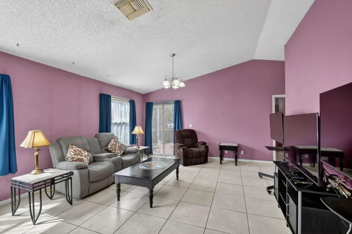 Living room has sliding glass doors that open to the screened patio