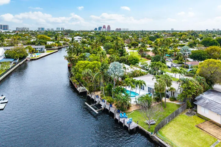 Aerial view of house, dock, pool, boatlift and backyard
