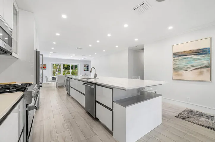 Spacious island with sink, convenient drawers and plenty of counter space and seating