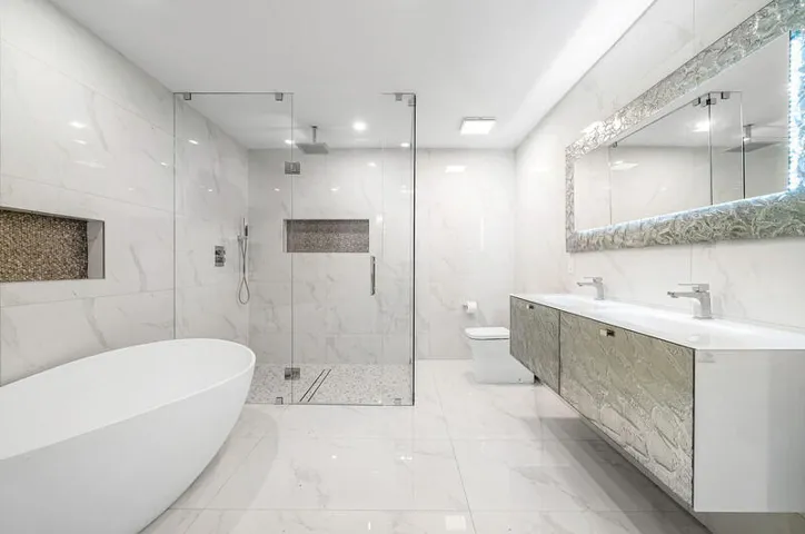 Primary ensuite bath with curbless shower, soaking tub, double vanity and Murano mirror