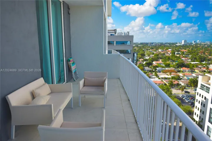 Large Balcony has glass sliding doors to the living room and to the bedroom.