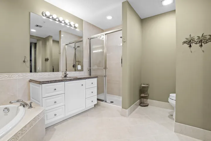 Dual sinks, large soaking tub, separate shower, and walk-in closets in primary bath