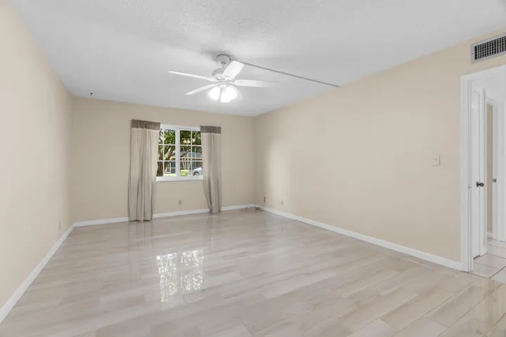 Spacious Primary Bedroom with Impact Windows and Porcelain Tiling