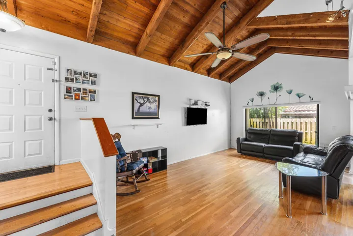 ENTRY INTO GREAT ROOM WITH WOOD HIGH BEAM CEILINGS