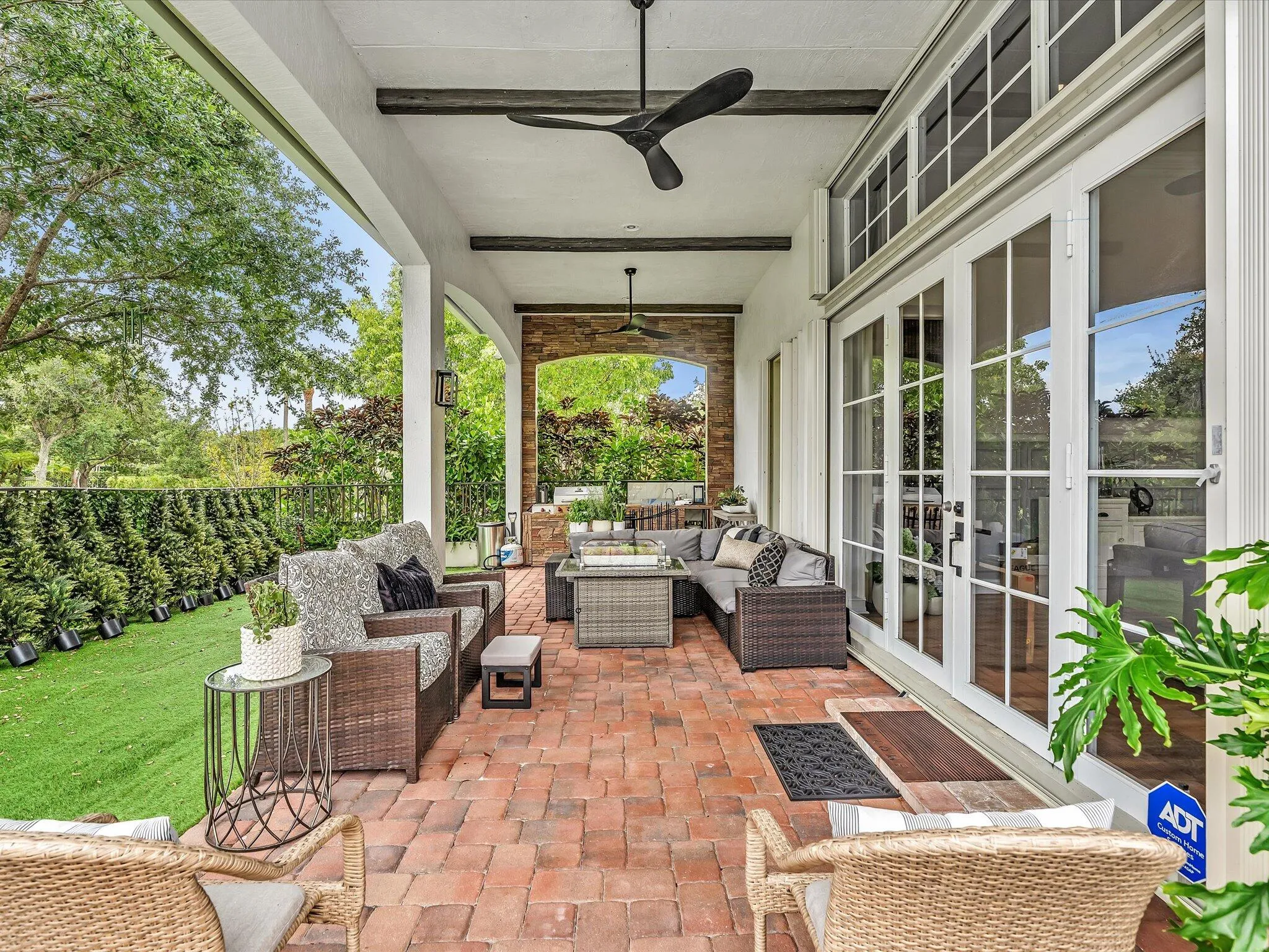 OUTDOOR LIVING AT IT'S FINEST WITH COVERED PAVED PATIO, AND SUMMER KITCHEN AND FENCED-IN!.
