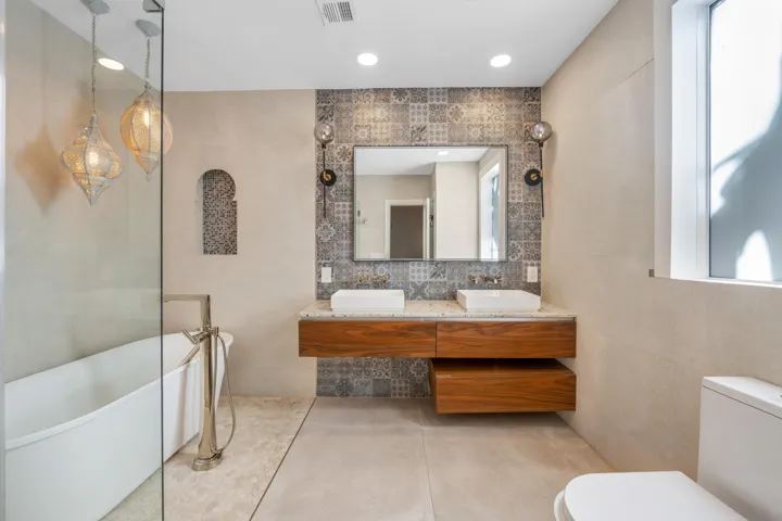 primary bath sith tub and shower and skylight