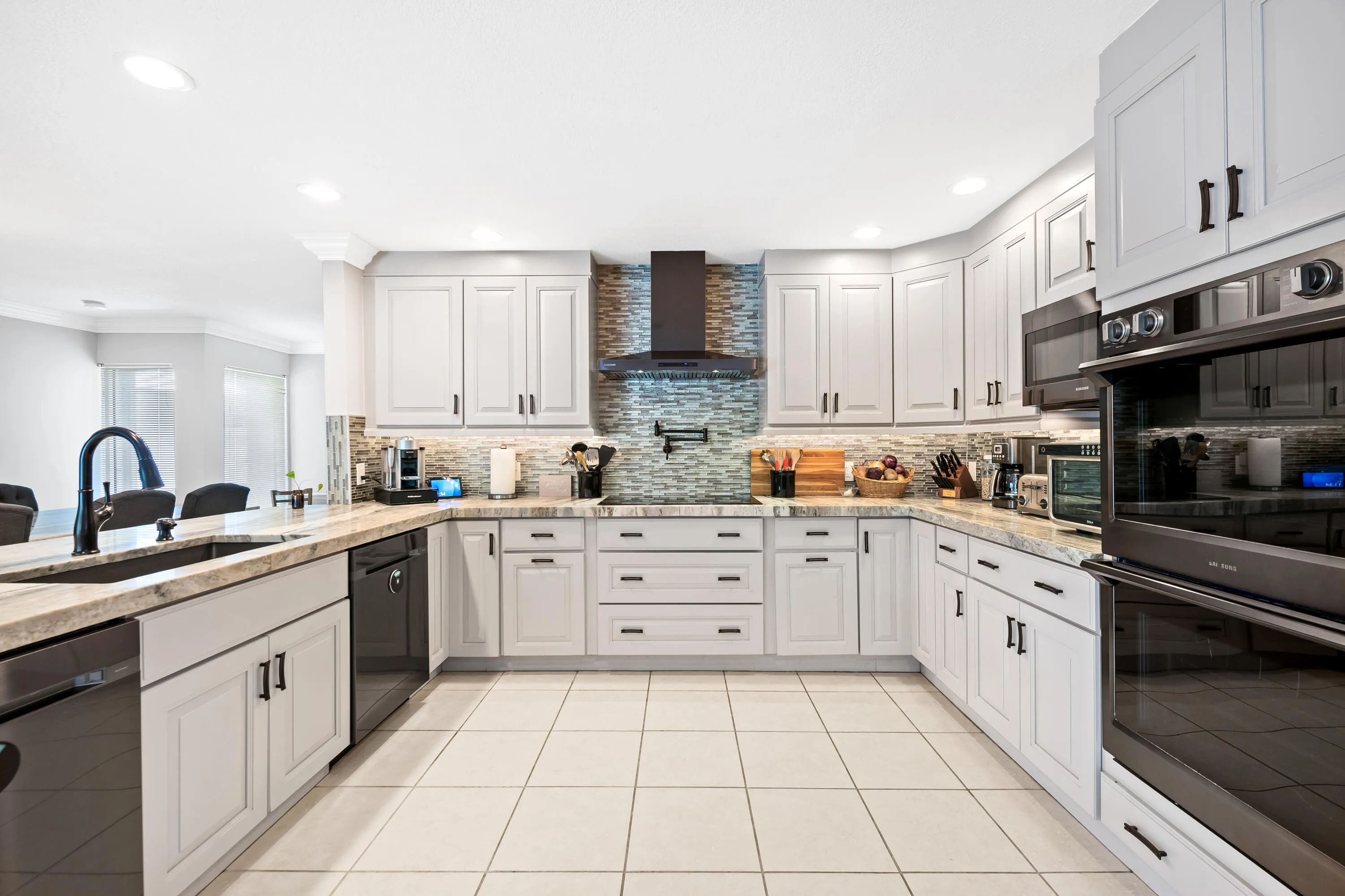 Kitchen with two dishwashers, pot filler, double oven, cook top, smart fridge and wine fridge