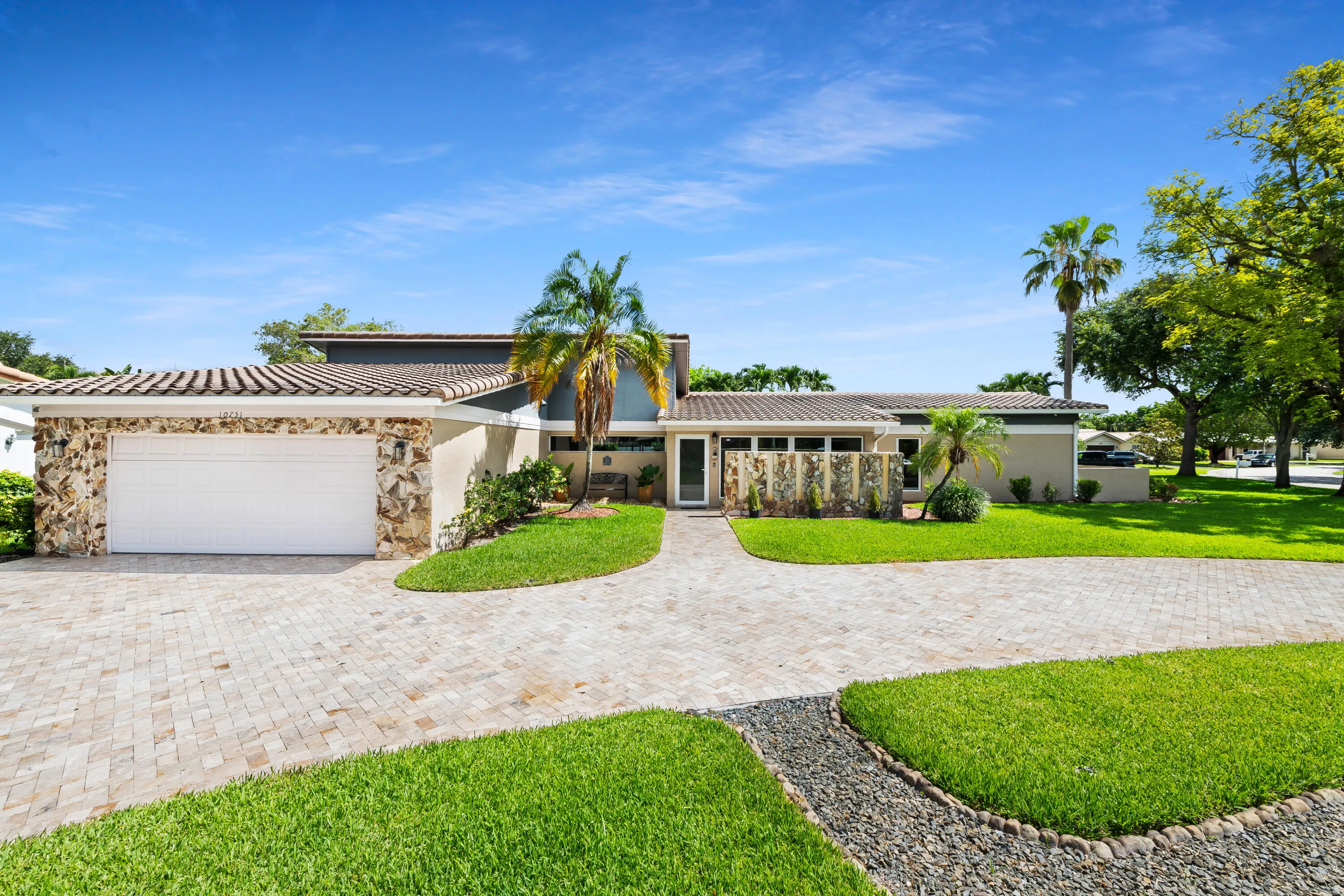 Front of house and lawn with huge half circle paver driveway