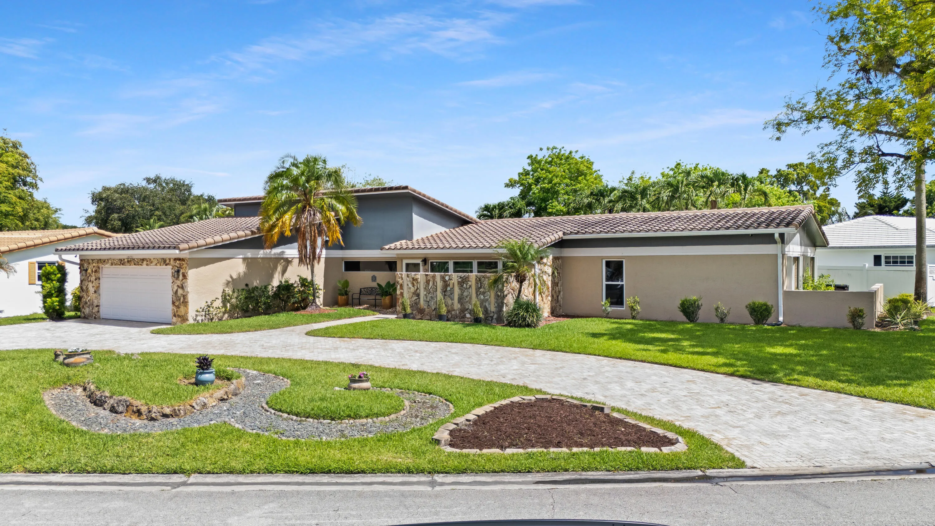 Front of house and lawn with huge half circle paver driveway