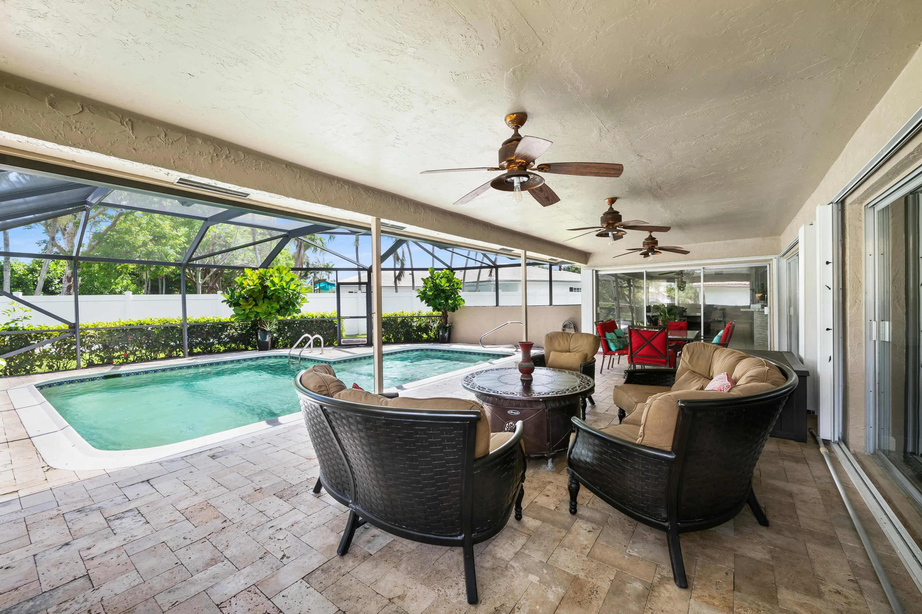 Screened back patio with pavers and saltwater pool
