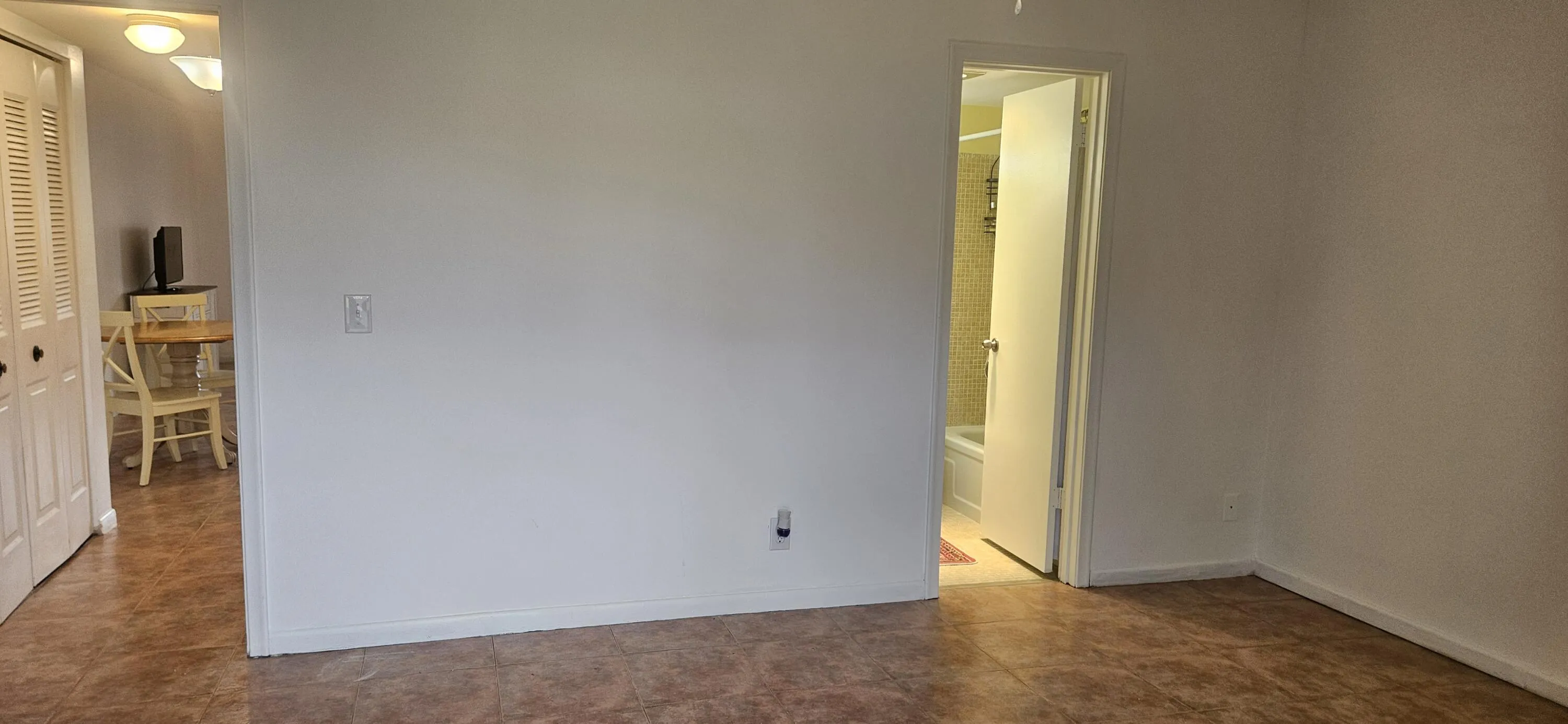 Opposite from Sliding door to patio, the door to the bedroom is a pocket door