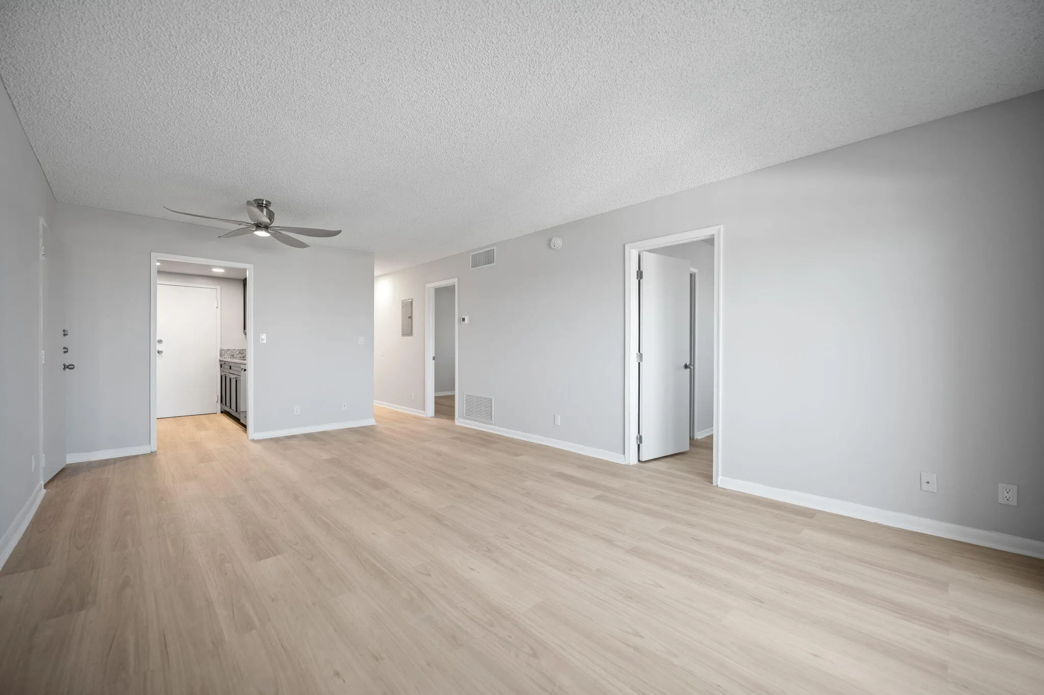 Unit 1407 living area with access to kitchen and the two bedrooms.