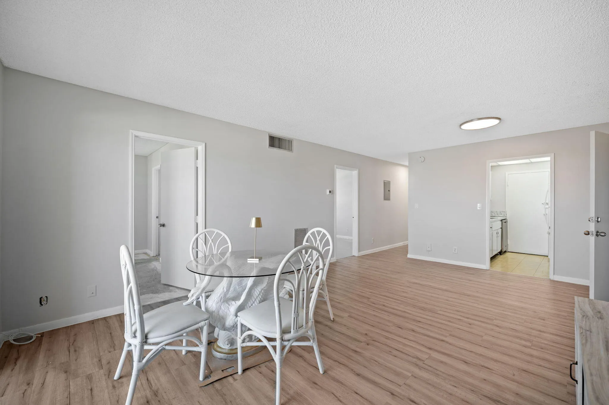 Unit 1406 living area, door to kitchen and two bedroom doors.