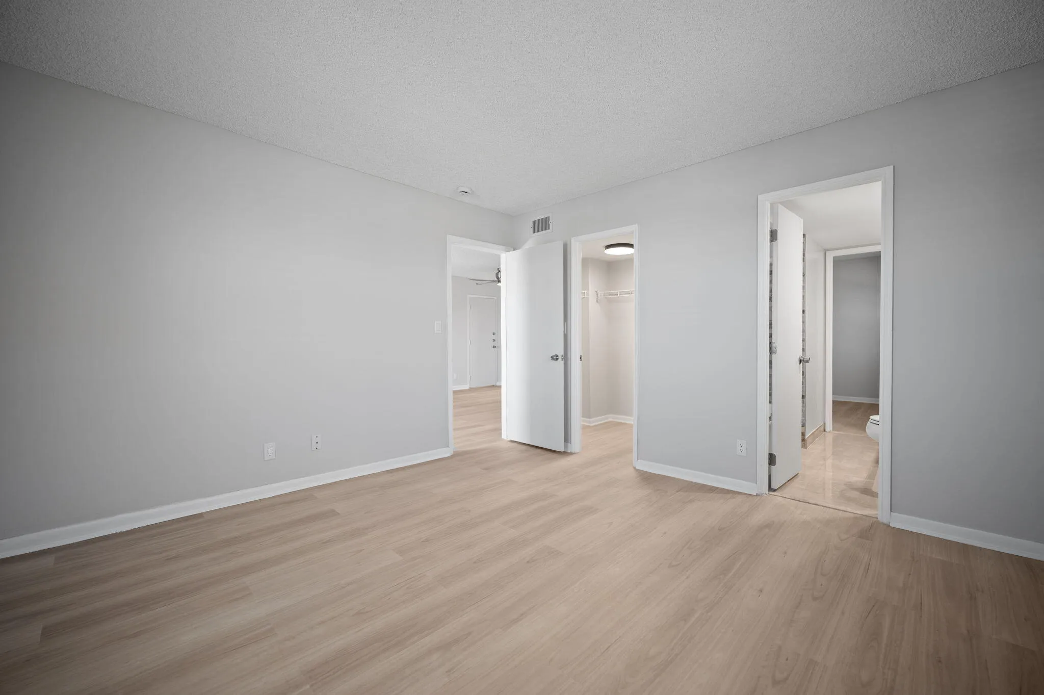 Unit 1407 main bedroom, closet door and entry to jack and jill bathroom.