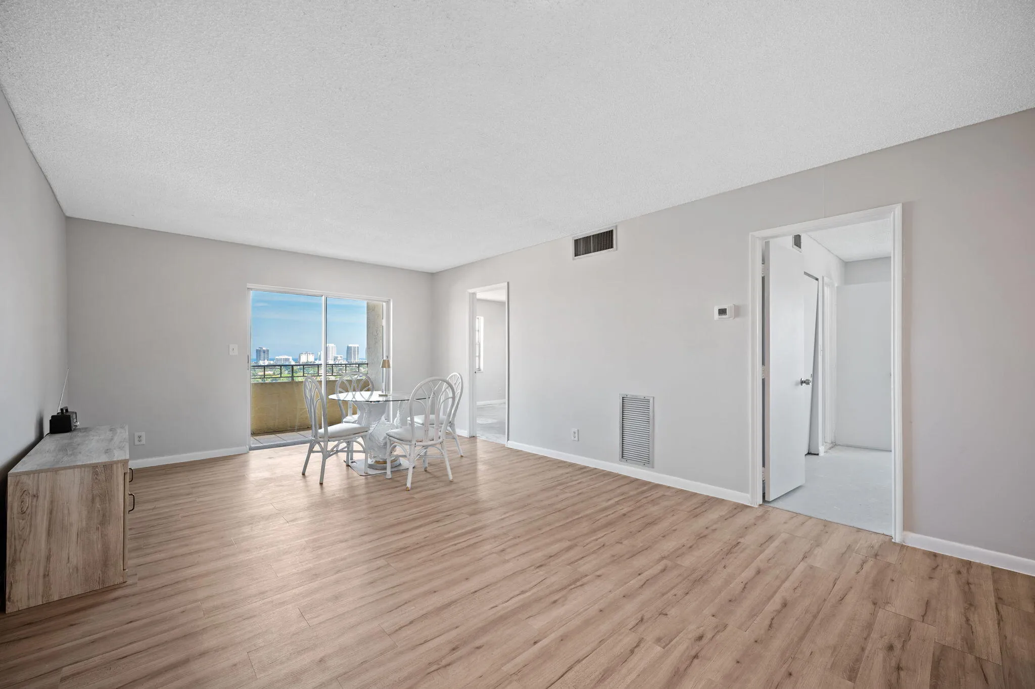 Unit 1406 Living area, the balcony and the two bedroom doors.