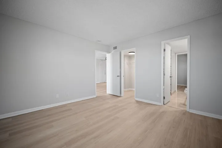 Unit 1407 main bedroom, closet door and entry to jack and jill bathroom.