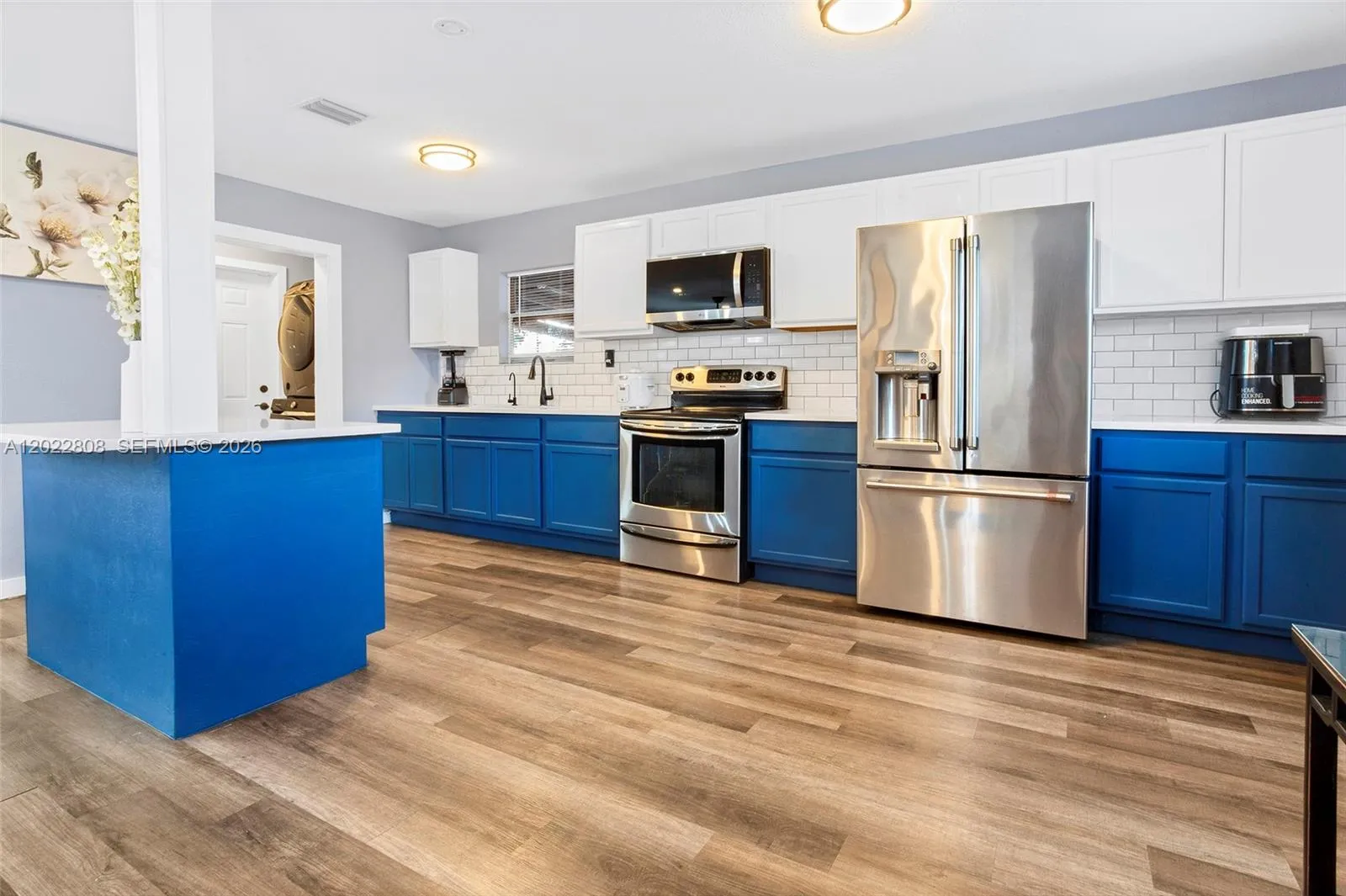 Modern open-concept kitchen featuring stainless steel appliances, stylish cabinetry, quartz countertops, and ample workspace—perfect for everyday living and entertaining.